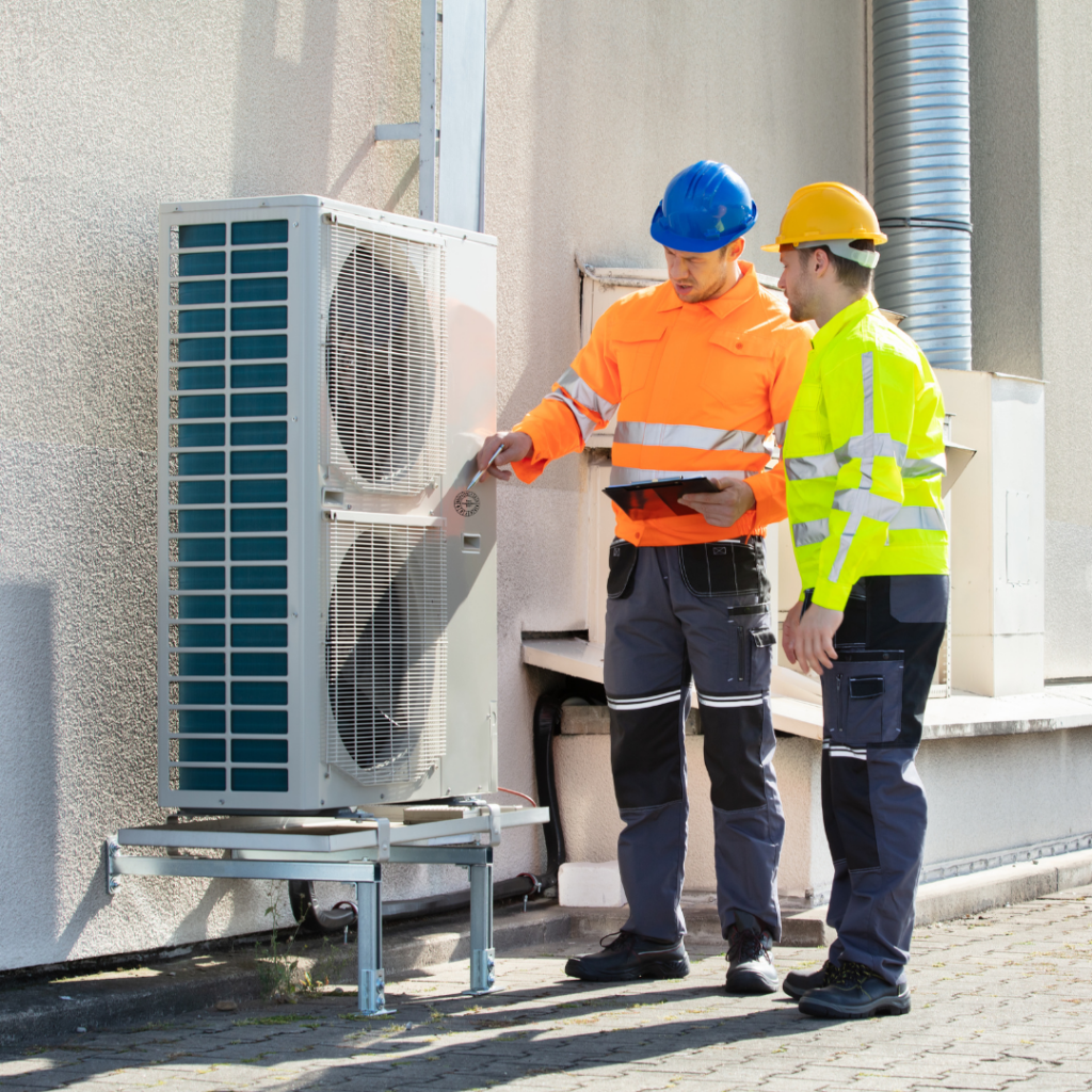 men checking an AC system