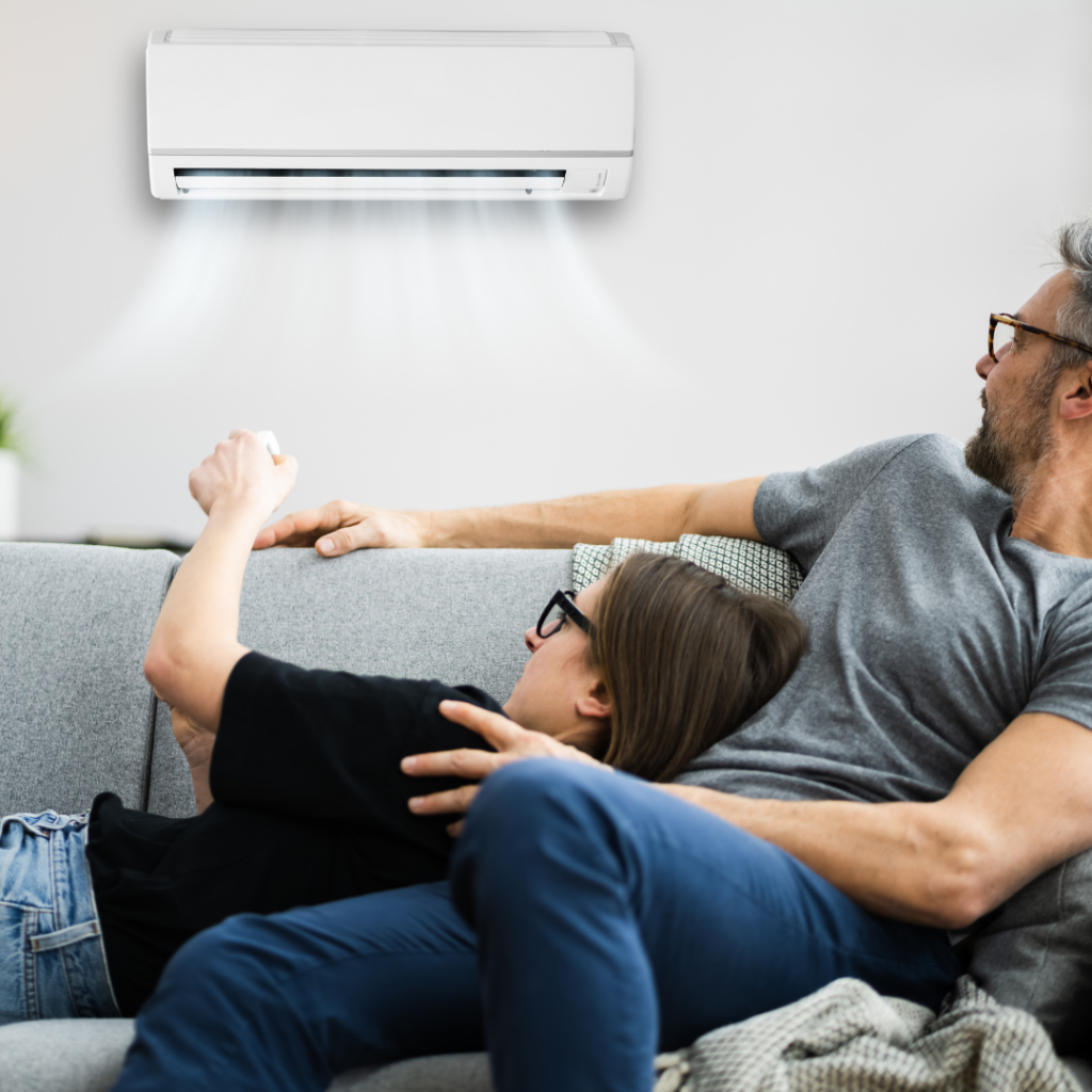 couple laying on a couch enjoying air conditioning
